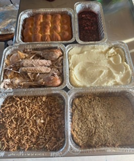 Family gathered around a table for a turkey dinner