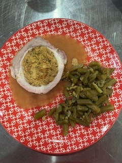 Stuffed pork loin sliced and plated for a catering event